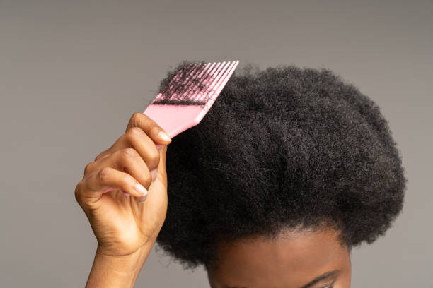 African woman combing curly hair